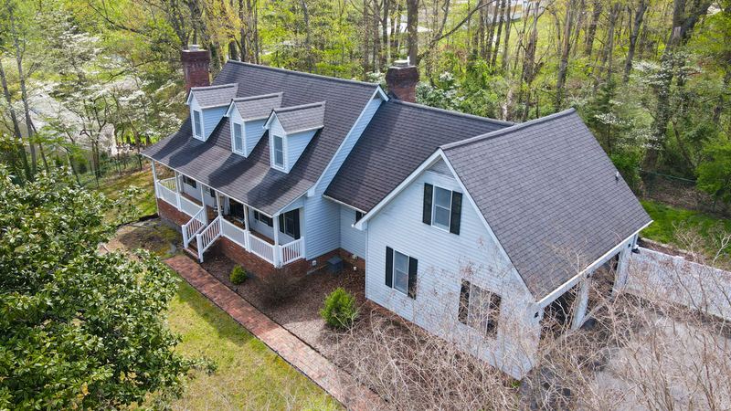 Aerial view of the same home from the side, showing the roofline and yard