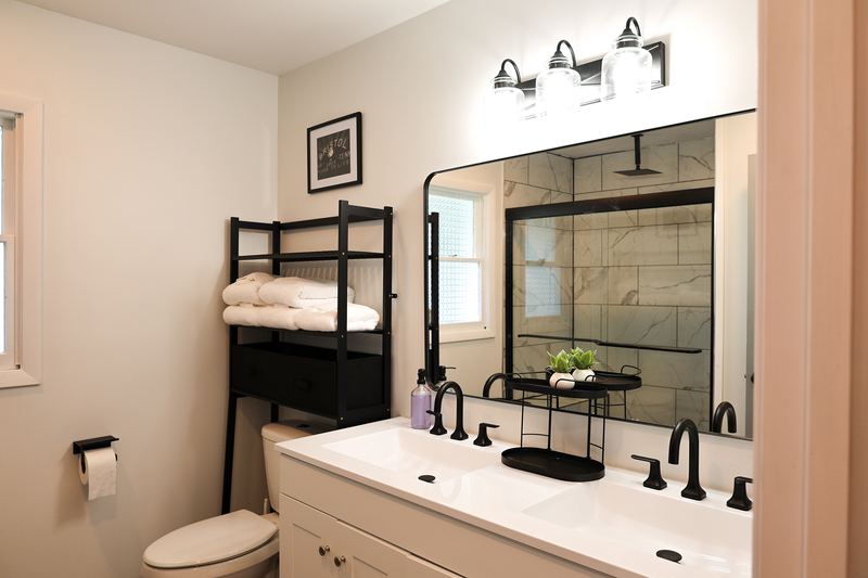 Updated bathroom with a double vanity and black fixtures